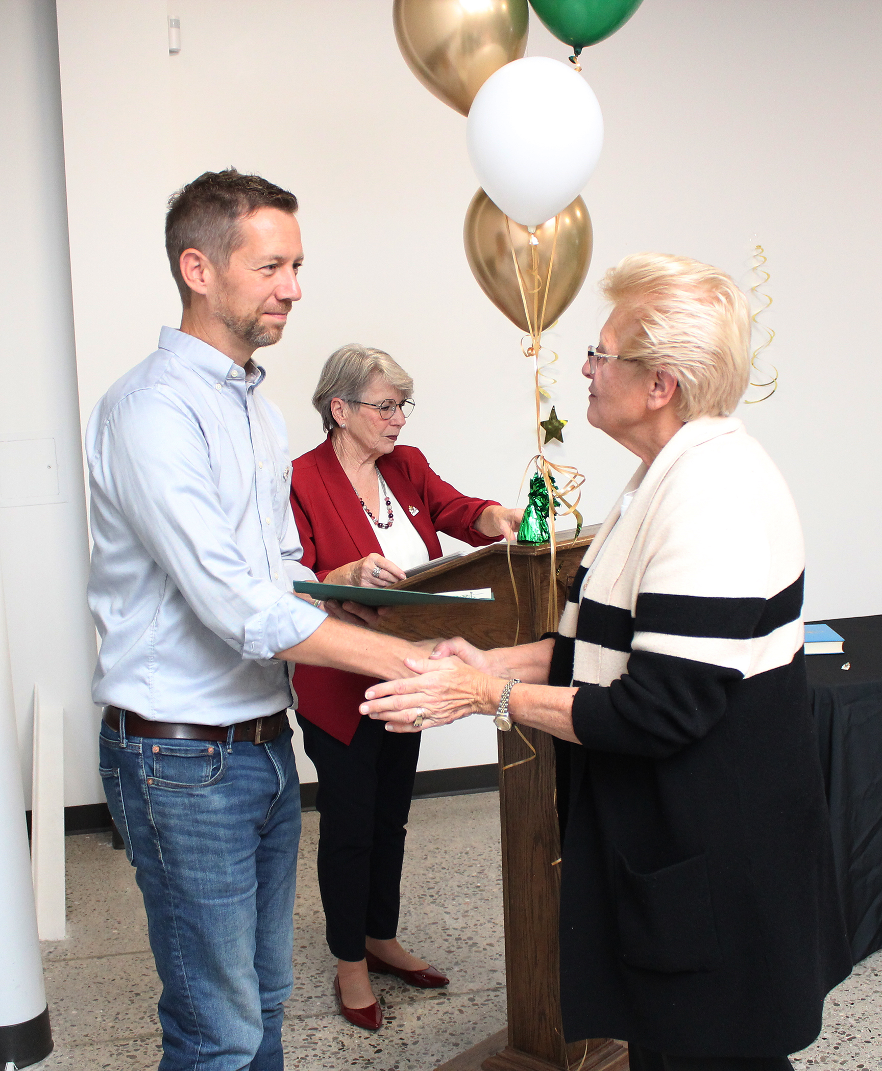 Scott Antonides accepts a certificate from Councillor Joann Chechalk, Mayor Ganann in the background