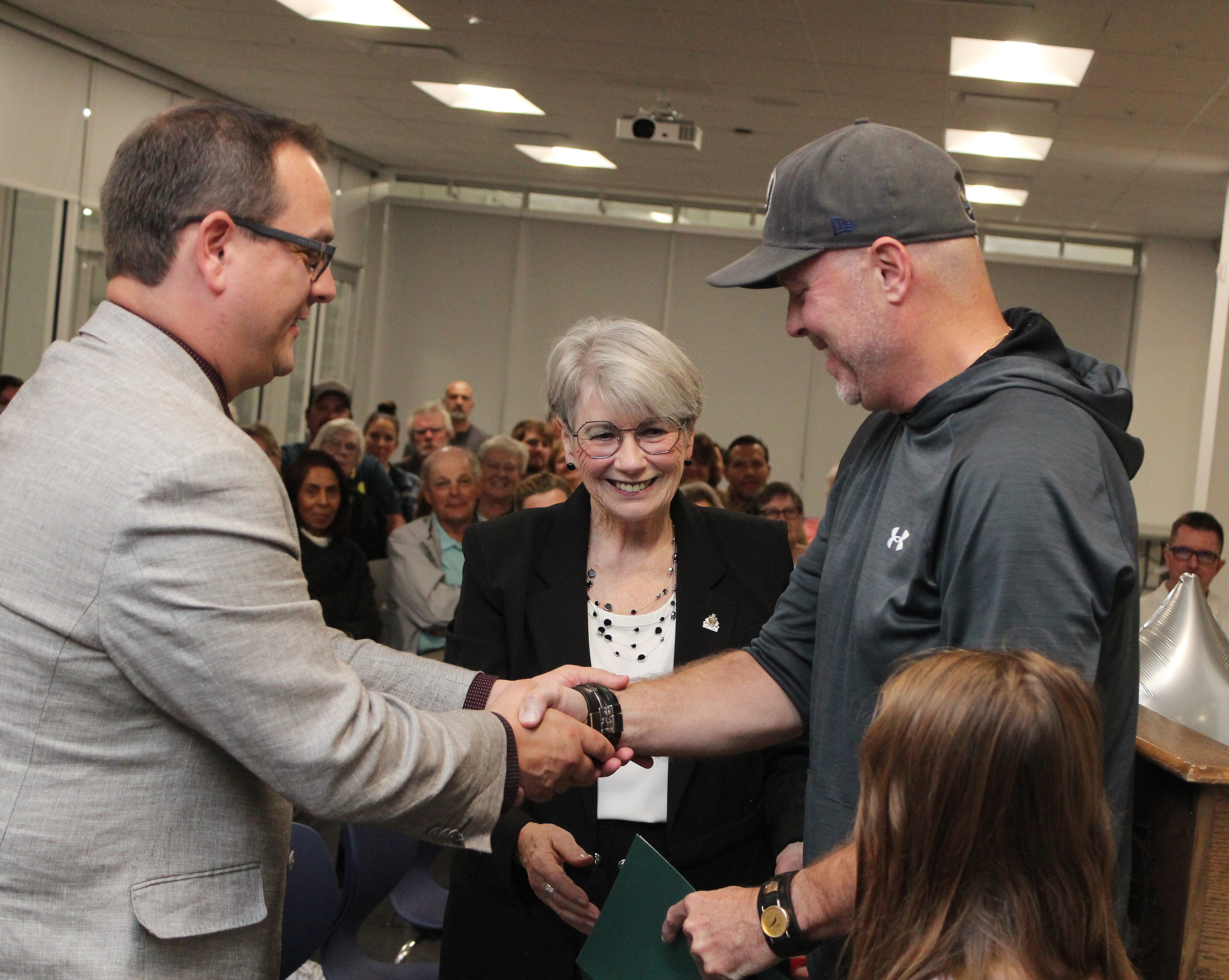 Councillor William Reilly and Mayor Cheryl Ganann congratulate Shawn Redmond