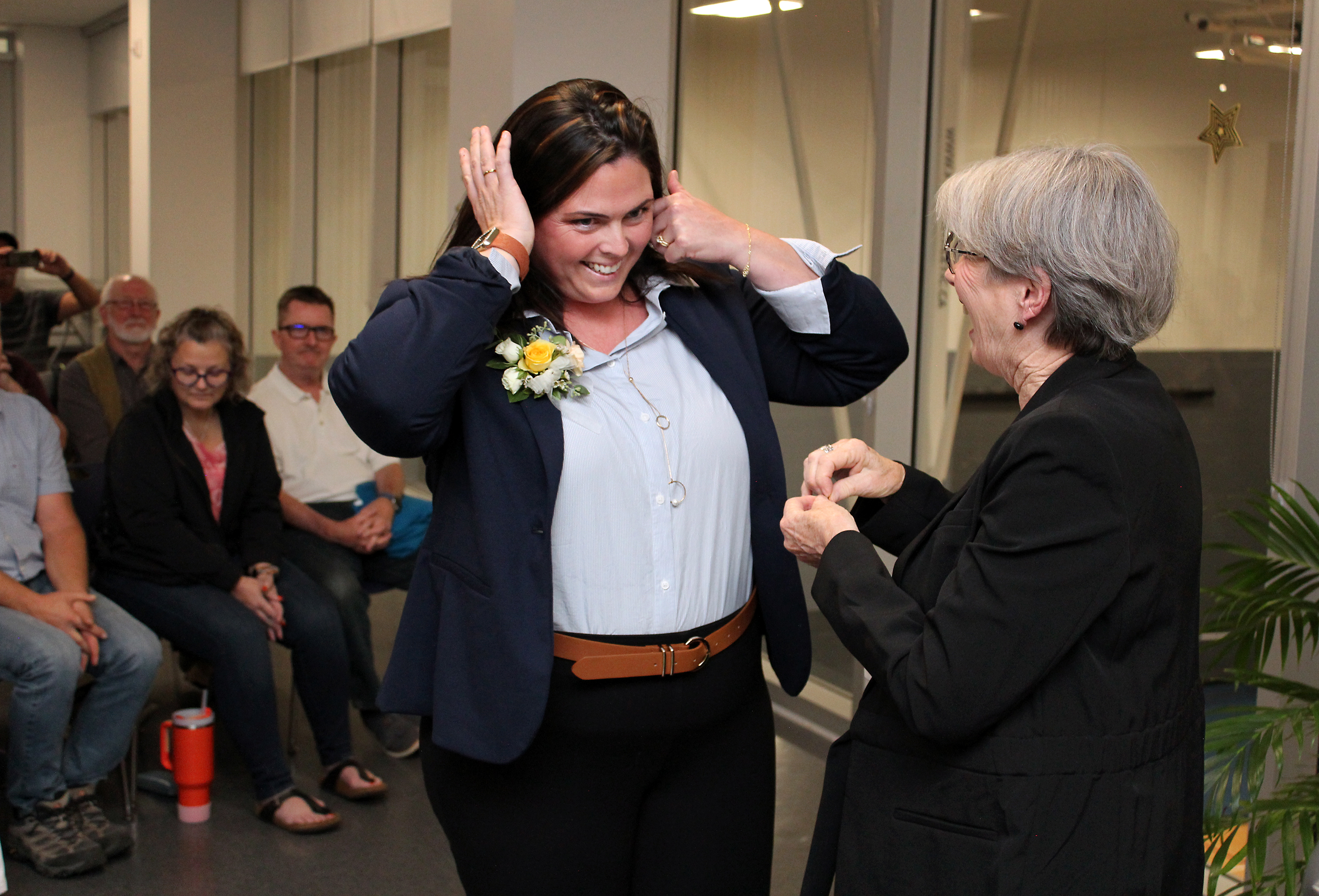 Mayor Cheryl Ganann presents a Township pin to Nicole Scime