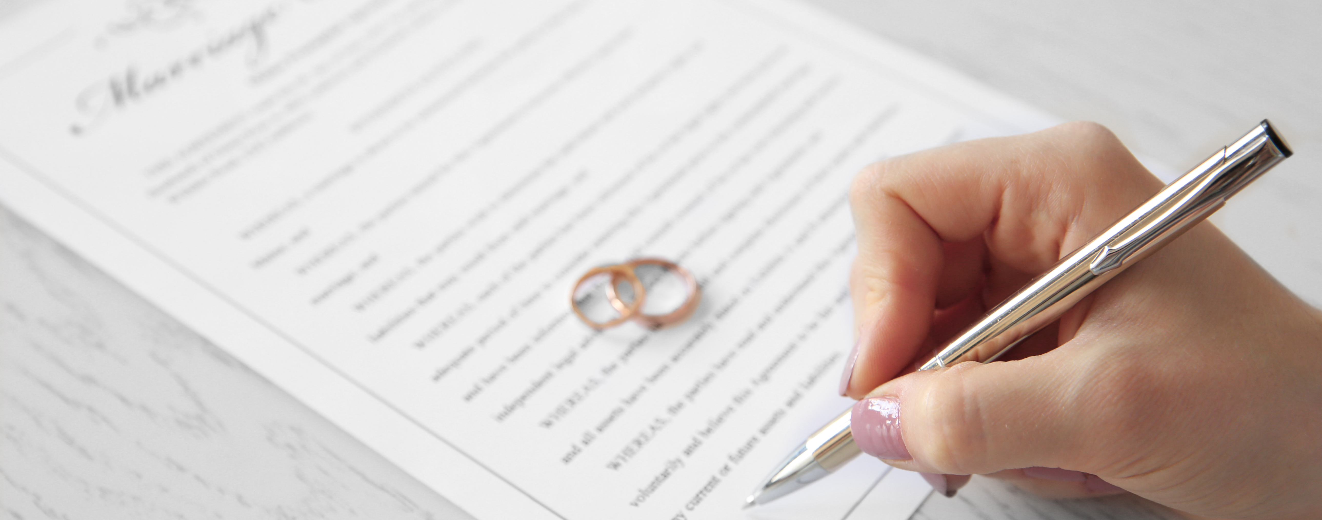 Hand signing a marriage licence